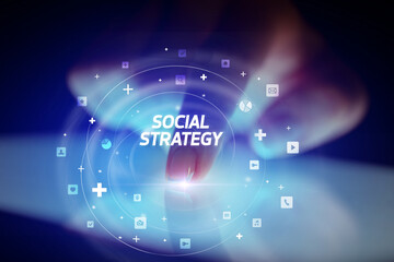 Finger touching tablet with social media icons and SOCIAL STRATEGY