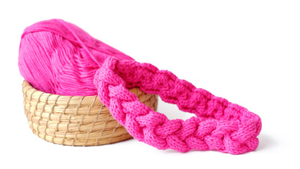 Braided knitting pattern with a ball of yarn on yarn basket with knitting needle hot pink yarn color