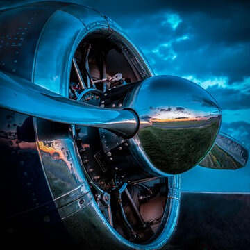 A T-6 Texas at the Oshkosh Air Show in 2019 reflects in the setting sun 