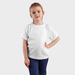 Template white t-shirt on a girl in blue jeans and a hand on the waist, empty clothes on a child for presentation of design and pattern.