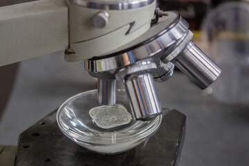 Close up of microscope with metal lens at laboratory