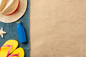 Fototapeta na wymiar Summer beach accessories and sun cream on the sand
