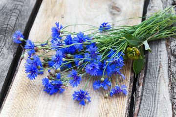 Cornflower on wooden background. Eco flowers. Selective focus, space in the zone blurring compositions for the production of advertising.