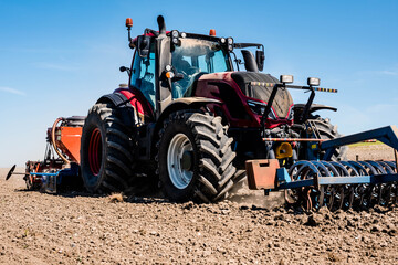 Fototapeta premium farmer in his tractor sowing in the fields