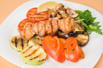 Grilled vegetables . Chicken kebab. Grilled vegetables on a white plate