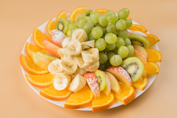 Fruit plate. Fruit sliced. Fruit on a white plate