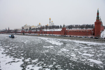 Moscow / Russia - February 17, 2017:  Kremlin Palace during winter and water in the river is freezing. Kremlin is an important iconic and landmark of Russia. - 357214652