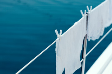 White laundry on line, clothes on board in sunlight