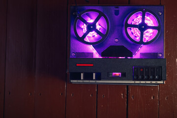 reel to reel audio tape recorder with purple led light strip. VU meter with "Recording" title