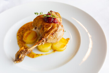 roasted duck leg with potato and orange sauce