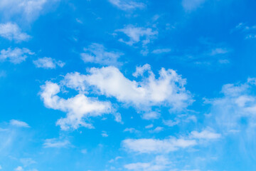 Naklejka na ściany i meble White clouds of small size on a blue sky in sunny weather