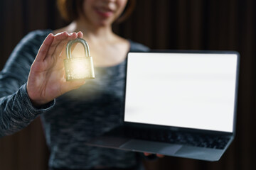 Woman holding gold master lock key with laptop is concept to lock a datas.