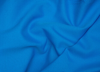 Fototapeta premium Creased blue gabardine. Rumpled texture. Folded fabric