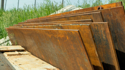 rusty iron sheets stacked on top of each other
