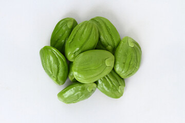 Bitter bean, Twisted cluster bean or Stink bean in wood plate on white background. thai name is sator 