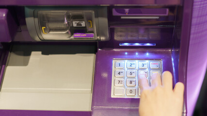 Woman finger pressing a button of Automated Teller Machine( ATM )
