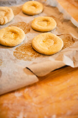 raw cookies bases on white baking paper ready for baking in the oven.