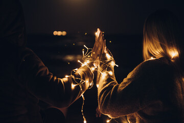 hands wrapped in light