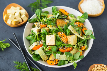 Fresh tofu salad with sesame seeds, corn salad, apricote and bamboo in the bowl