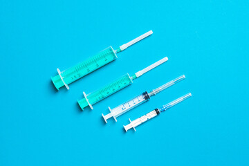 Top view of medical syringes on colorful background. Health care concept with copy space