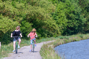 young person riding bikes on towpath