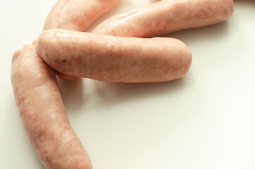 Raw classic British sausage made from prime cuts of pork on the white background
