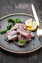 marinated herring with red onion, lemon and basil
