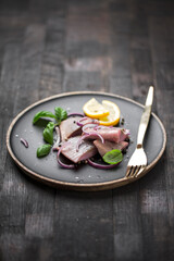 marinated herring with red onion, lemon and basil