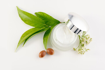 jar of cream for skincare with argan nuts