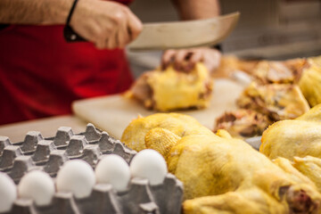 Chef preparing food, a chicken being cut  to start diner preparation