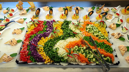 Vegetable salads. Decorations from various vegetables. Beautiful compositions arranged on plates.