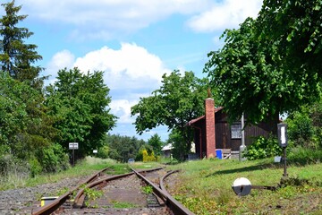 Fototapeta na wymiar tracks to the loading ramp of the old railway station on a disused line, Svobodne Hermanice, North Moravia, Czech Republic