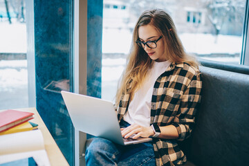 Happy young student enjoying e learning on modern laptop computer