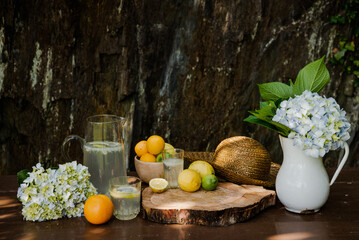 Obraz na płótnie Canvas Fresh handmade lemonade on a wooden table in a sunny day outdoors. Still life.