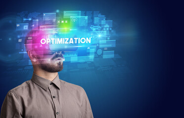 Businessman looking through Virtual Reality glasses with OPTIMIZATION inscription, innovative security concept