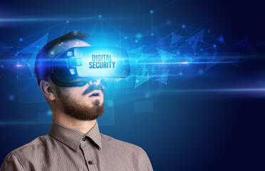 Businessman looking through Virtual Reality glasses with DIGITAL SECURITY inscription, cyber security concept