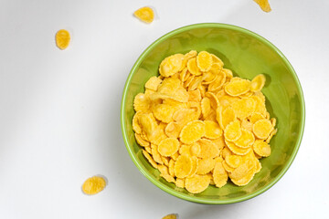 Bowl with corn flakes isolated on white background