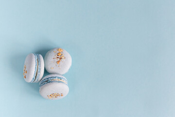 Tasty french macaroons on a light blue pastel background.