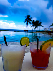 Cocktail drink glass in close-up on a Caribbean beach in Cancun, Mexico.