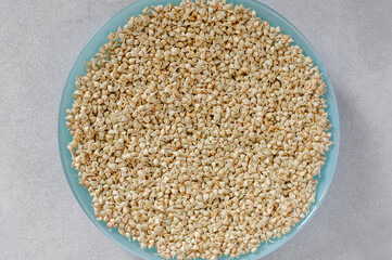Plate with green buckwheat. Sprouted buckwheat. Organic vitamin food. Gray background. Top view. Close-up.