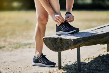 Girl tying her slippers on a bench to go running