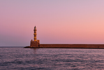 old lighthouse of xania in red dawn and calm mediterranean sea