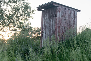 Old wooden double outhouse in the remote Russian village