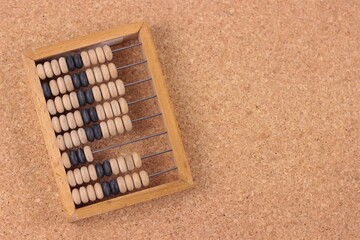 Education, training and account concept. Old wooden abacus on pure wooden cork background.Copy space for text