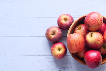 Close up of fresh apple in a bowl on wooden table 
