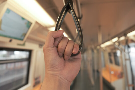 A man in public sky train in the city - Powered by Adobe