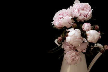 bouquet of peonies against a black background, vintage style