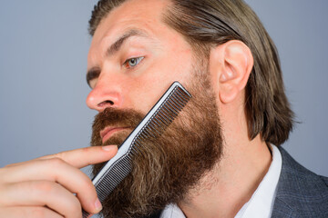 Barbershop. Professional beard care. Hairdresser. Salon for men. Close up portrait of bearded man...