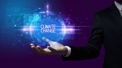 Man hand holding CLIMATE CHANGE inscription, technology concept
