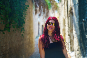 Fototapeta premium Happy woman traveler is walking and exploring Greek island of Rhodes, Dodecanese, Greece